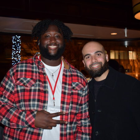a couple of men standing together