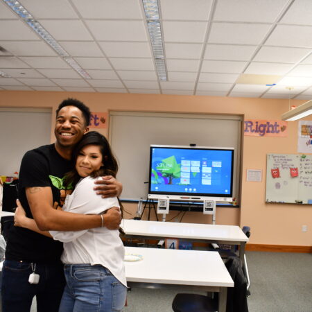 people hugging in a classroom