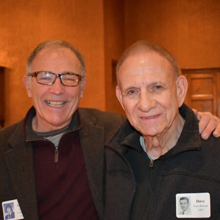 a couple of men smiling