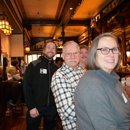 a group of people standing in a restaurant