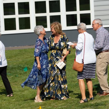 a group of people standing on grass
