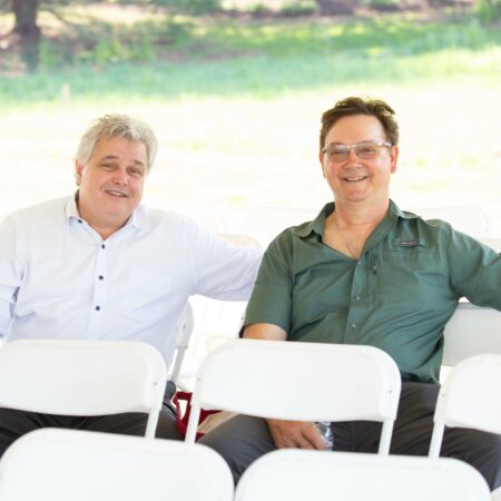 a couple of men sitting in chairs