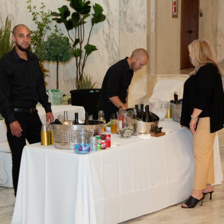 a group of people standing around a table