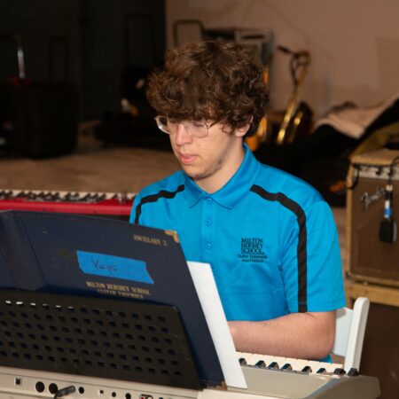 a person sitting at a piano