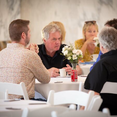 a group of people sitting at tables