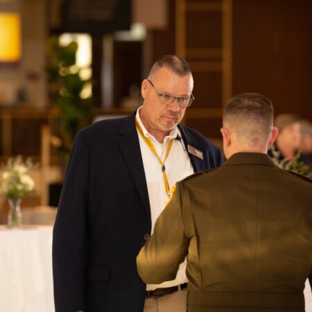 a person in a suit talking to another person