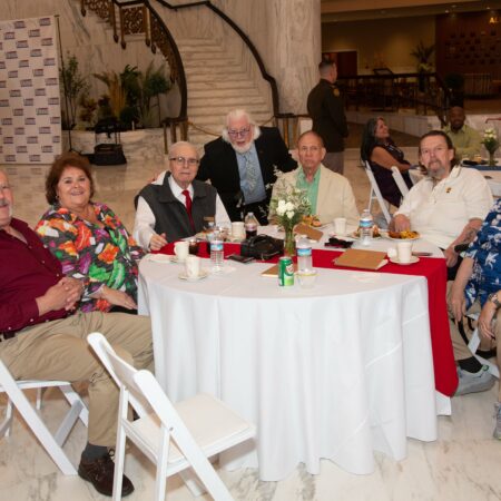 a group of people sitting around a round table