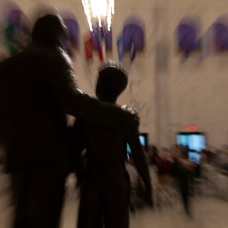 a blurry image of a person hugging a person