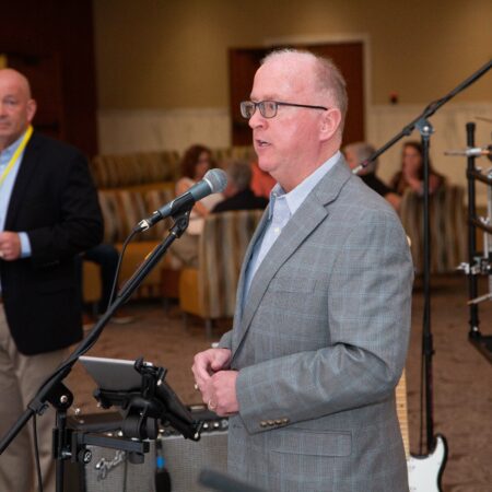 a person standing in front of microphones