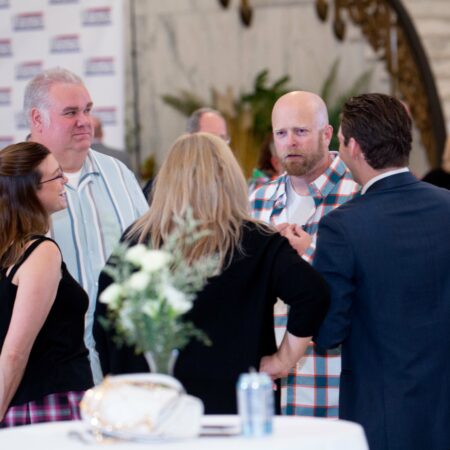 a group of people standing around a table
