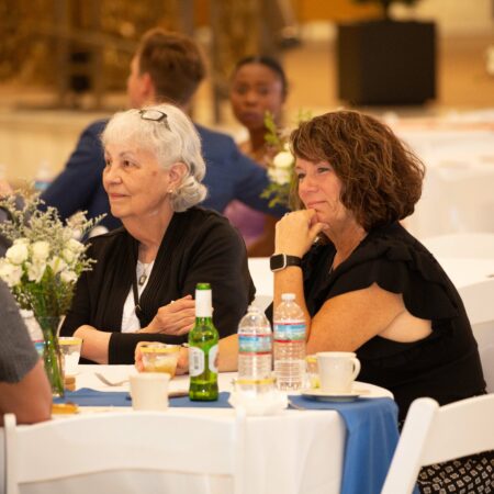 a group of people sitting at tables