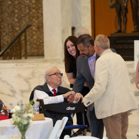 a person in a wheelchair with a person in a suit