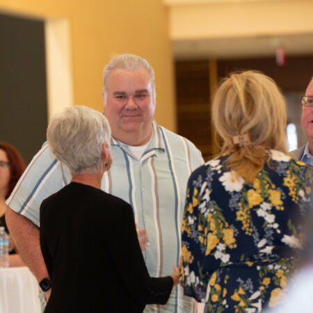 a group of people standing around each other