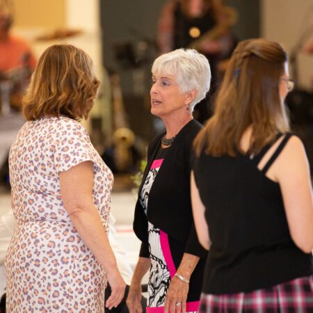 a group of women standing in a room