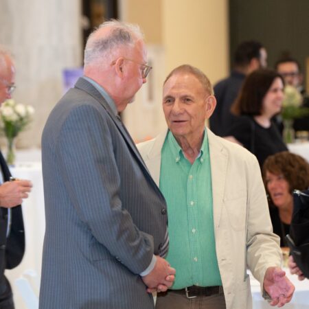 a person in a suit talking to another person