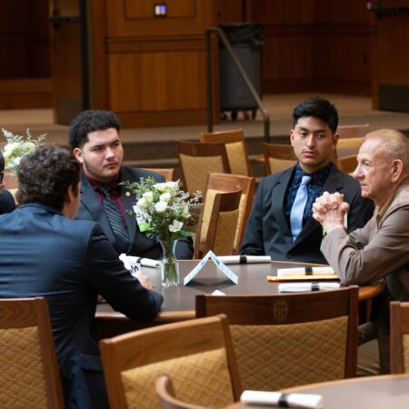 a group of people sitting around a round table