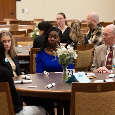 a group of people sitting at a round table