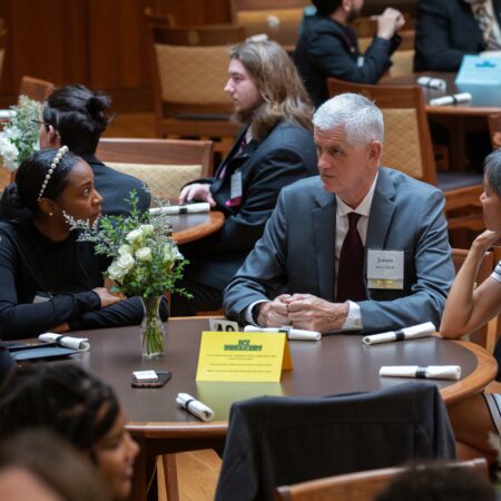 a group of people sitting at a round table