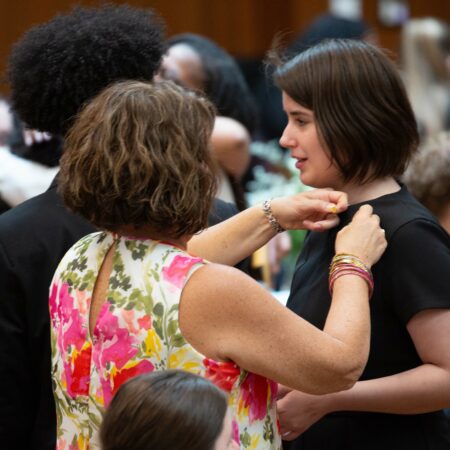 a person helping another person to dress