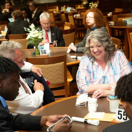 a group of people sitting around a table