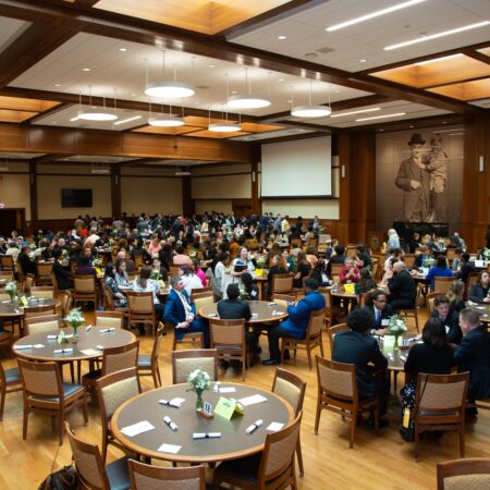 a group of people sitting around tables in a room
