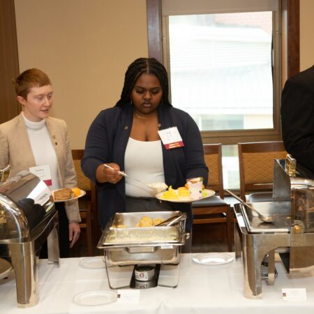 a person serving food at a buffet
