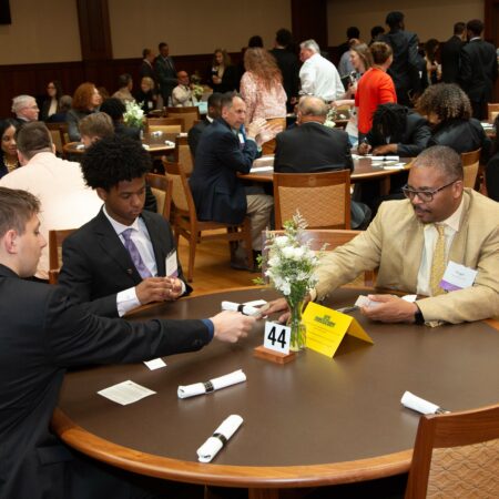 a group of men sitting at a round table