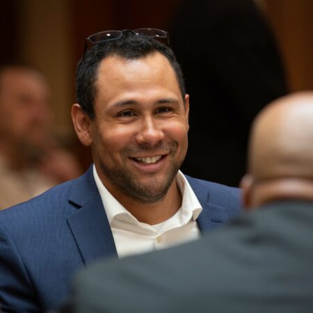 a person in a suit smiling