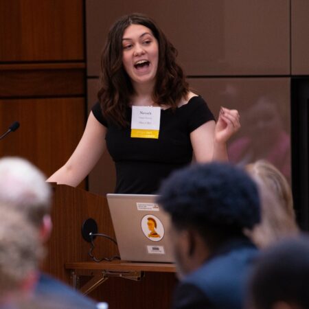 a person standing at a podium with a laptop