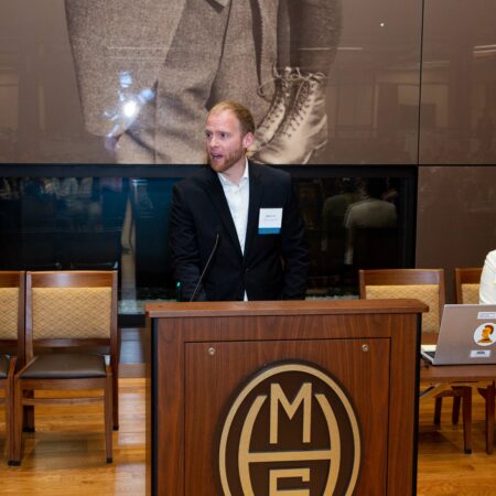 a person standing behind a podium