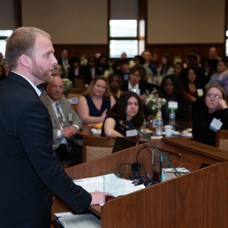 a person standing at a podium