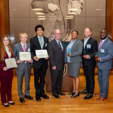a group of people holding certificates