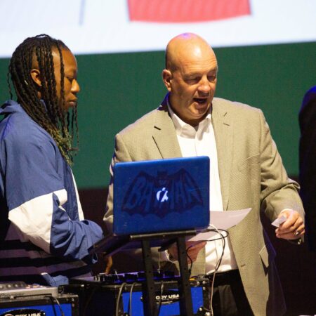 a person standing next to a laptop