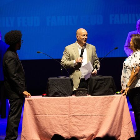 a person standing on a table with a microphone
