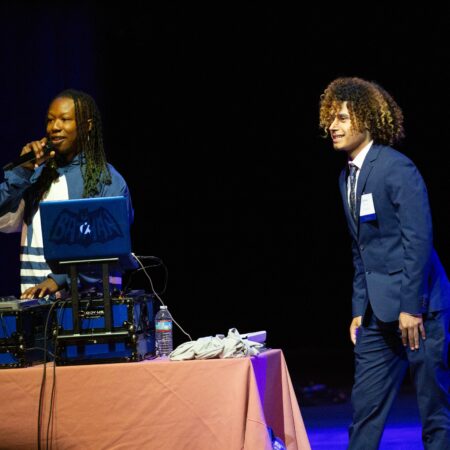 a person in a suit and tie standing next to a person in a suit and tie