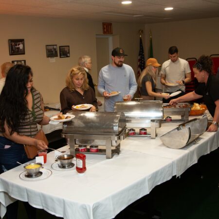 a group of people standing around a table