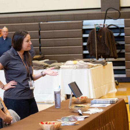 a person standing next to a table