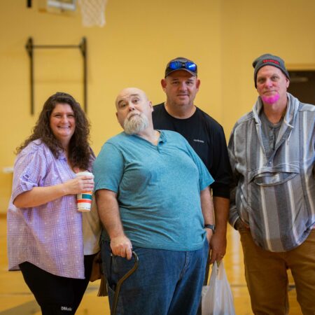 a group of people standing in a gym