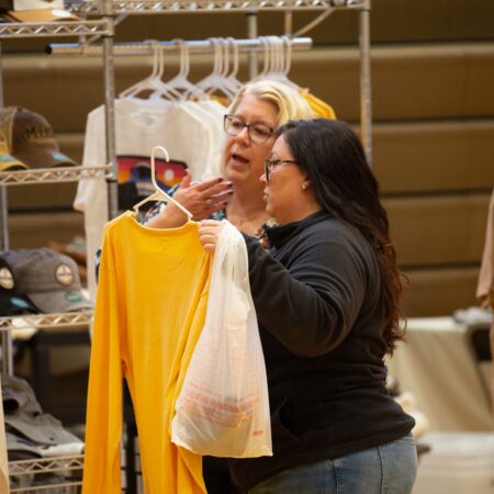 a person looking at a yellow shirt