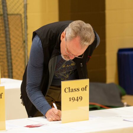 a person signing a class of 1940
