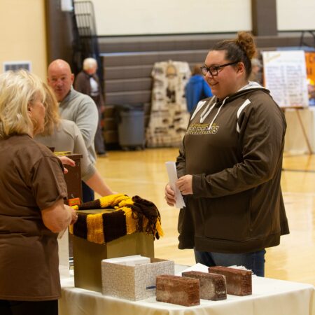 a person standing at a table with food items on it