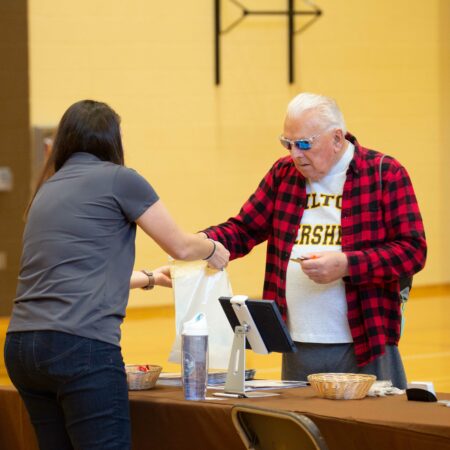 people standing next to a table