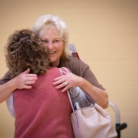 a person hugging another person