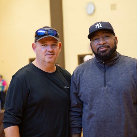 a couple of men standing together