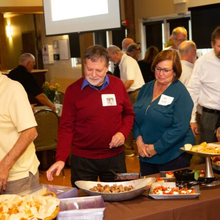 a group of people standing around a table