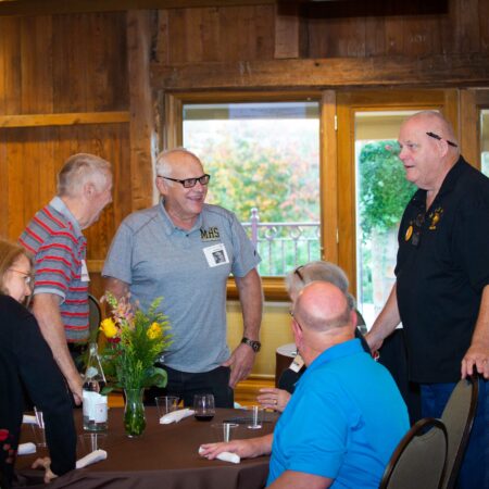 a group of people standing around a table