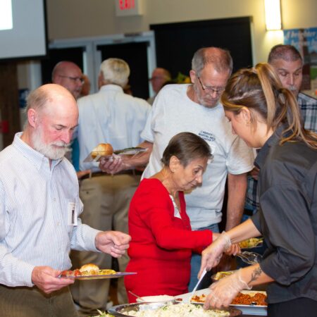 a group of people serving food