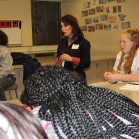 a person speaking to a group of students