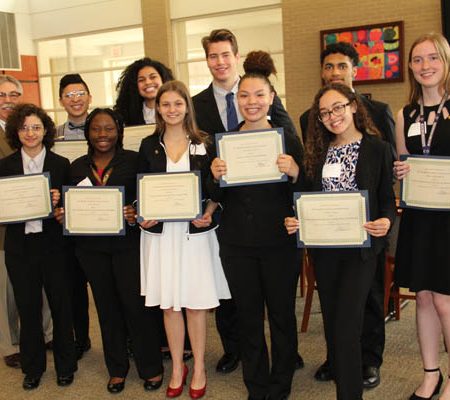 a group of people holding certificates