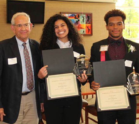 a group of people holding certificates